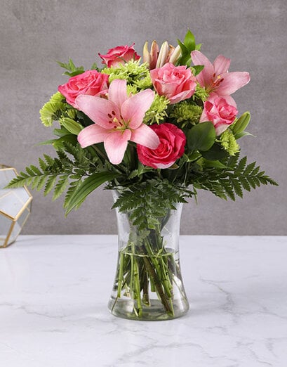 Lush Pink Lilies And Cerise Roses In A Vase